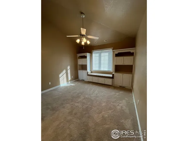 a view of an empty room with chandelier