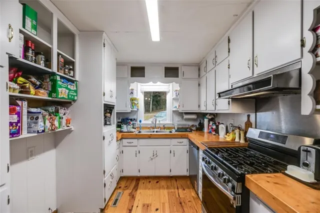 a kitchen with stainless steel appliances granite countertop a stove and a sink
