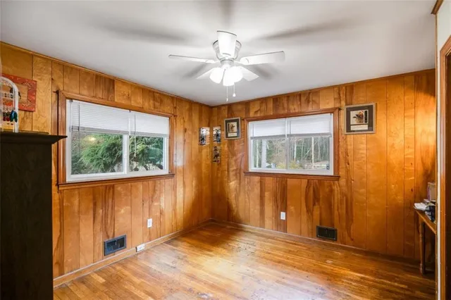 a view of a bedroom with wooden floor and closet