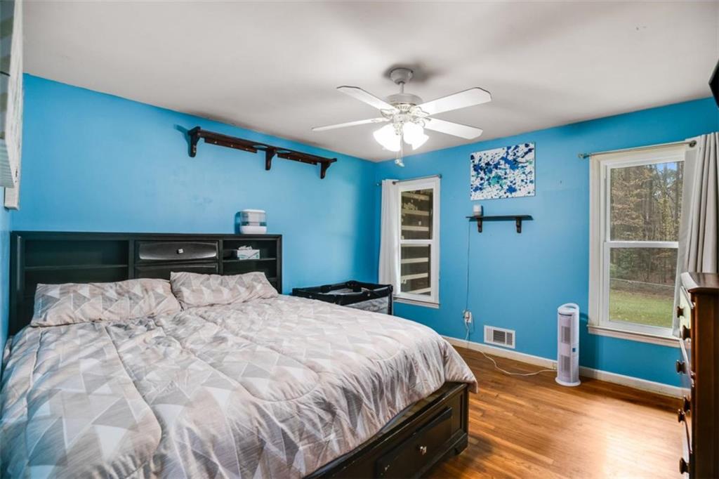 809 Laurel Street Bremen, GA 30110 - Photo 19 of 34 a bedroom with a large bed and a chandelier