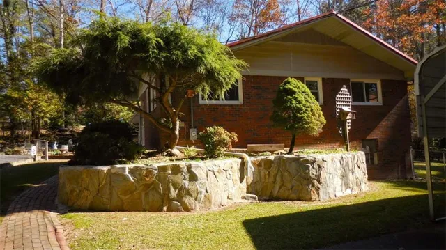 a view of yard with swimming pool and trees in the background