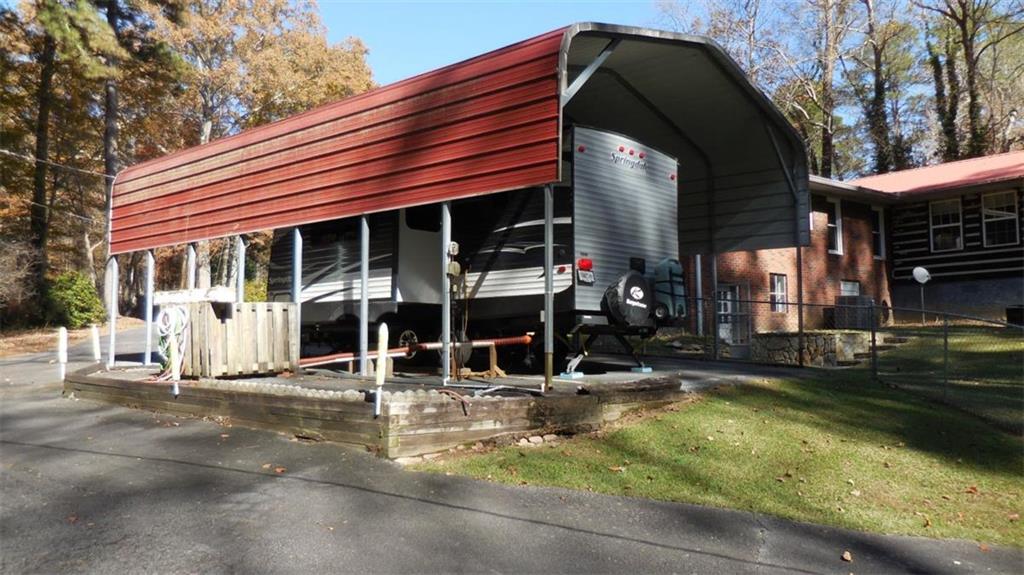 809 Laurel Street Bremen, GA 30110 - Photo 29 of 34 a view of a house with floor to ceiling windows and a basket ball poll