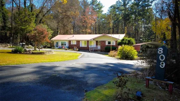 a view of a house with swimming pool and porch with furniture
