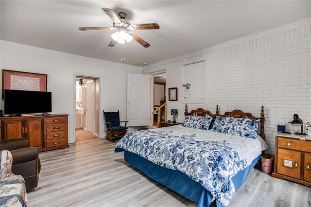 a bedroom with a bed and a television