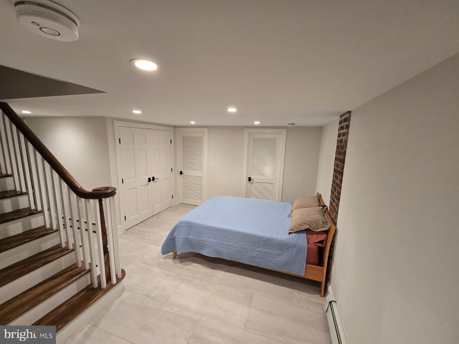 109 Moore Street Princeton, NJ 08540 - Photo 15 of 26 a spacious bedroom with a bed and a chandelier