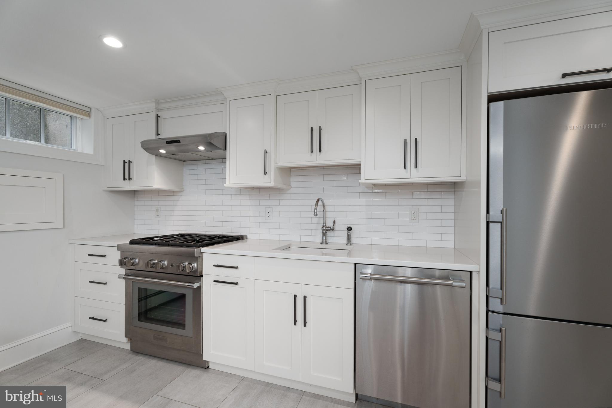 109 Moore Street Princeton, NJ 08540 - Photo 7 of 26 a kitchen with white cabinets and white stainless steel appliances