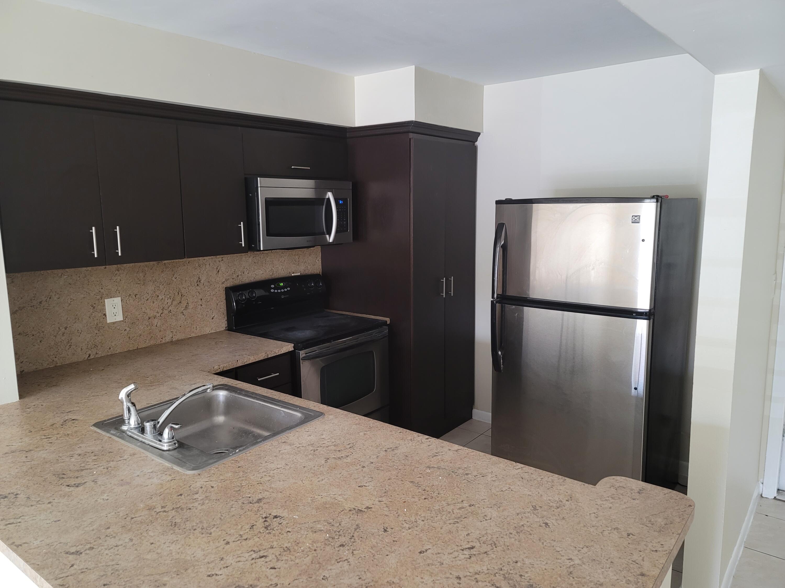 a kitchen with a refrigerator and a sink