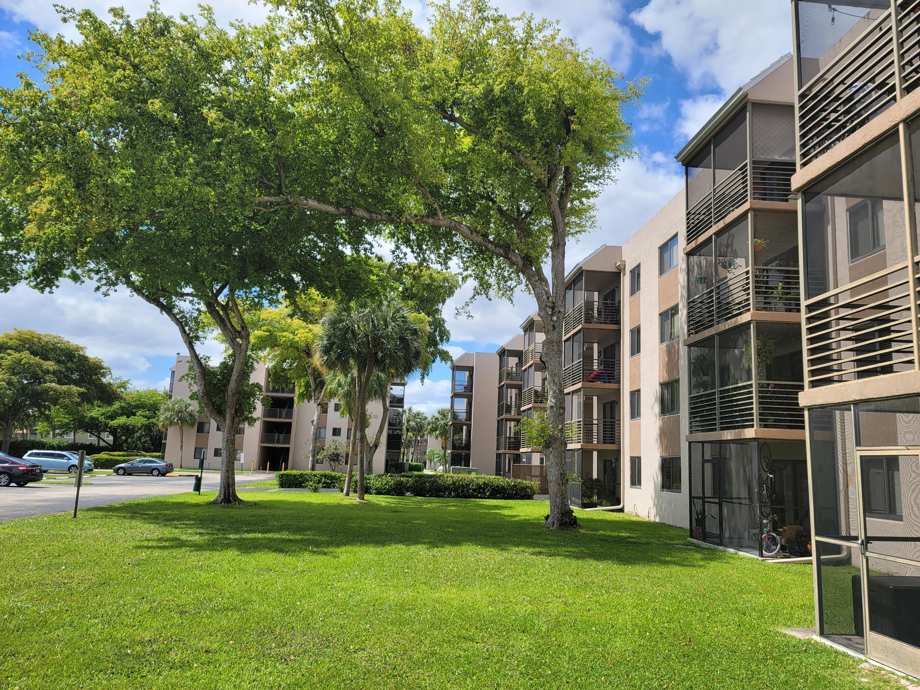3700-3730 North Pine Island Road, Unit 249 Sunrise, FL 33351 - Photo 16 of 18 front view of a building with a yard