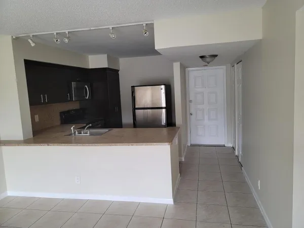 a kitchen with a sink and a refrigerator