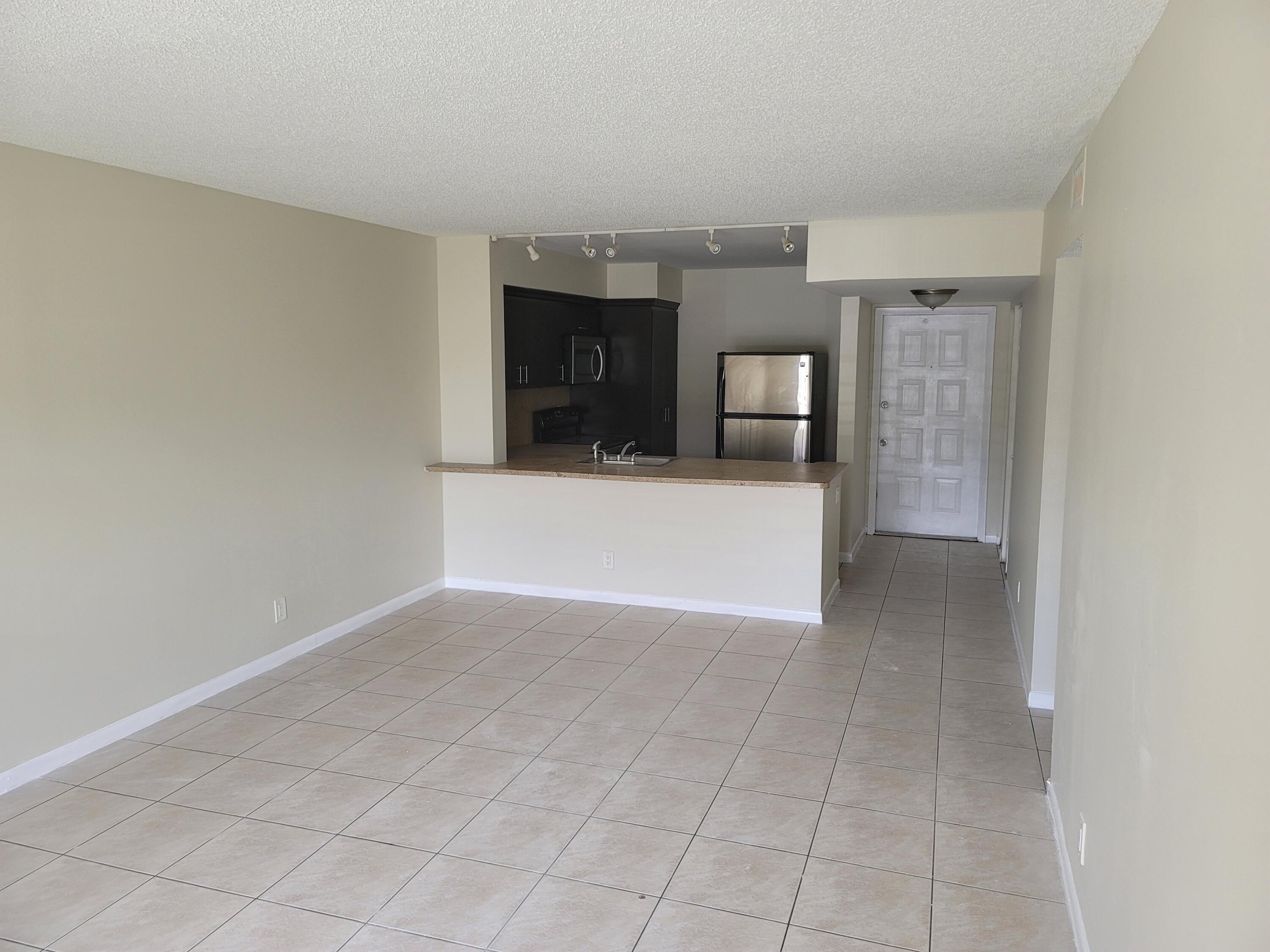 3700-3730 North Pine Island Road, Unit 249 Sunrise, FL 33351 - Photo 4 of 18 a view of a hallway to room and kitchen