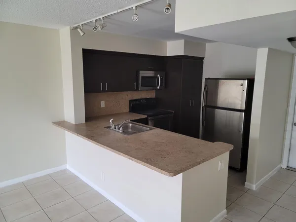 a kitchen with stainless steel appliances a refrigerator and a stove