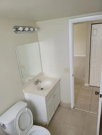 a white toilet sitting next to a bathroom sink