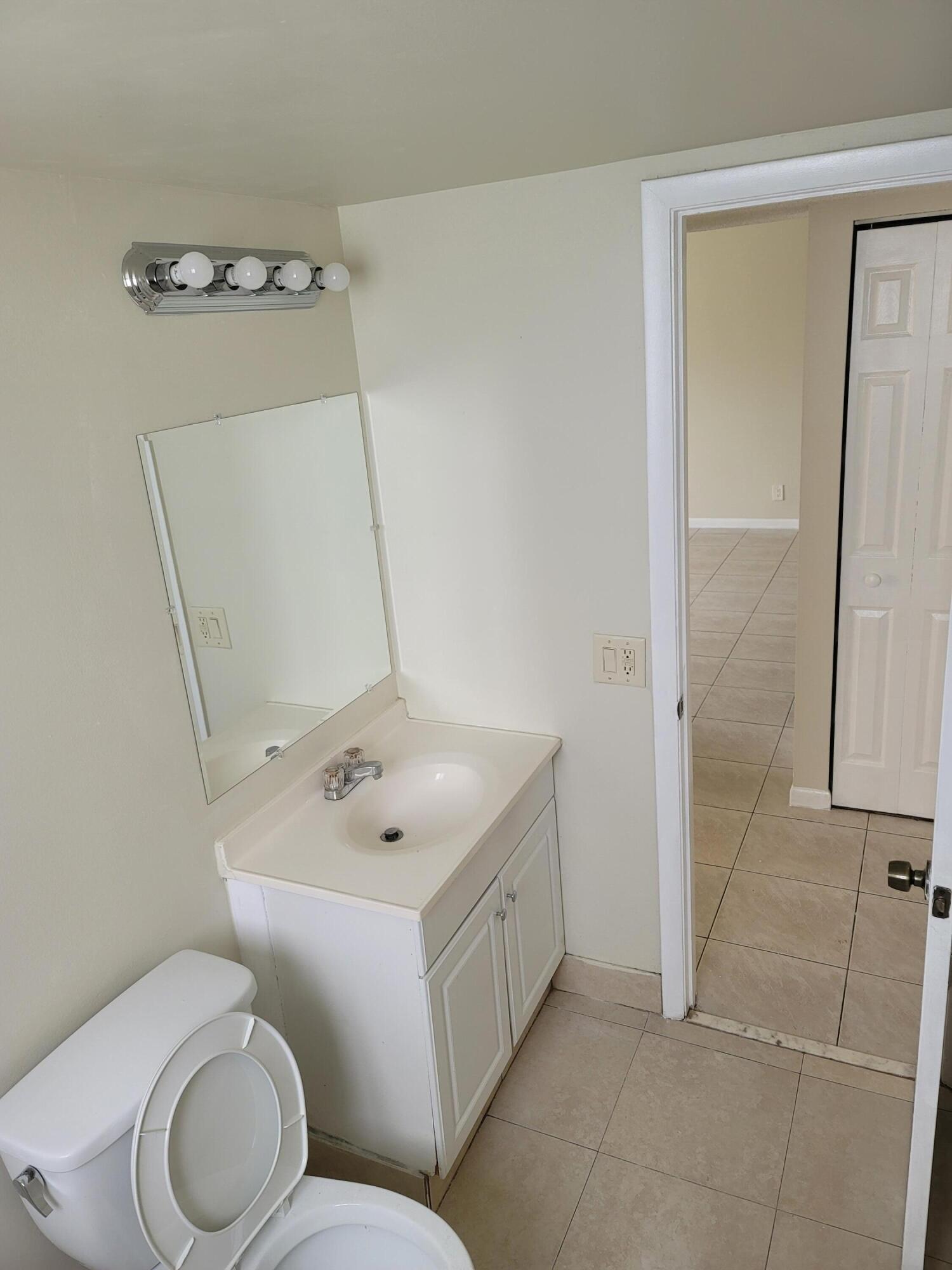 3700-3730 North Pine Island Road, Unit 249 Sunrise, FL 33351 - Photo 6 of 18 a white toilet sitting next to a bathroom sink