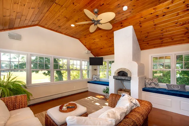 a bedroom with furniture and a large window