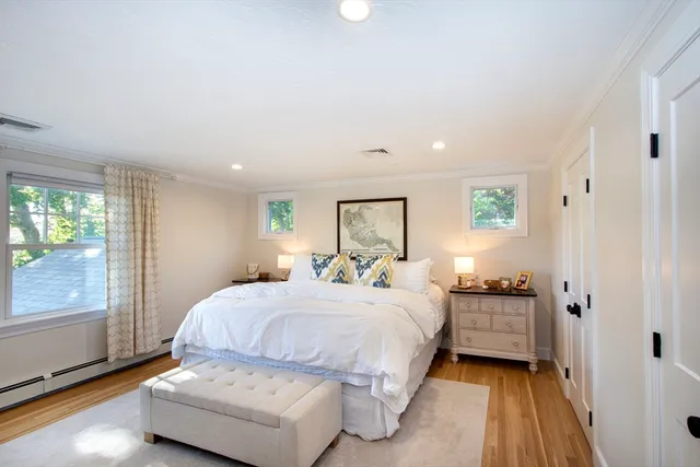 a bedroom with a bed and large window with outer view