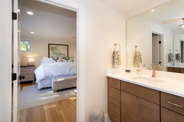 a en suite bathroom with a double vanity sink and a mirror
