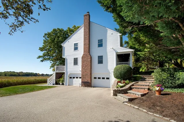 a view of backyard with outdoor seating and plants