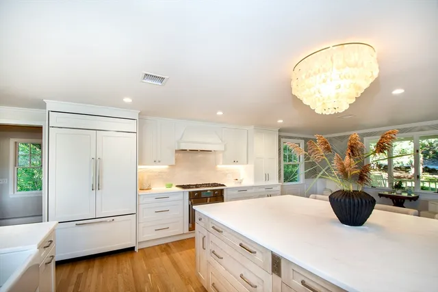 a kitchen with a refrigerator and a stove