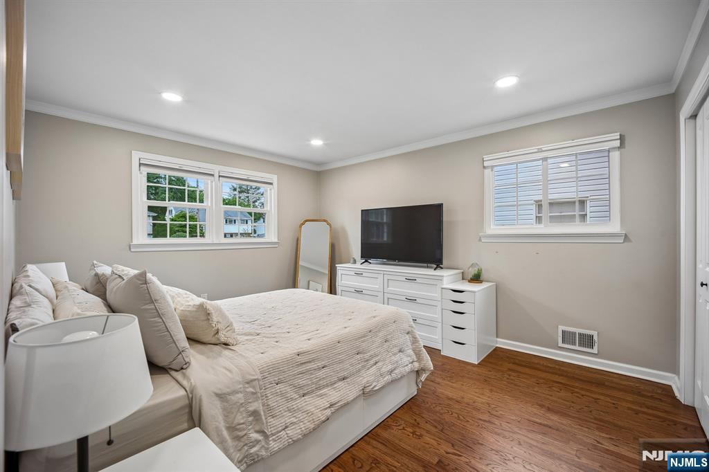 23 Andover Place Bloomfield, NJ 07003 - Photo 15 of 42 a bedroom with a bed and a flat screen tv