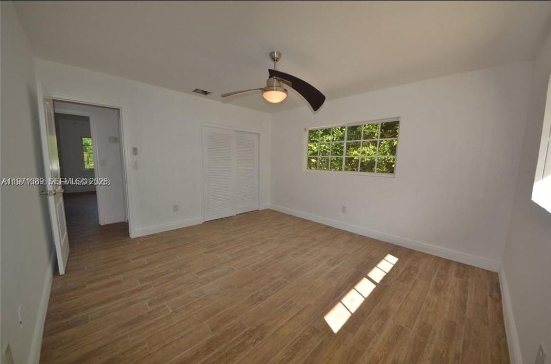 510 Bird Road Coral Gables, FL 33146 - Photo 4 of 9 wooden floor in an empty room with a window