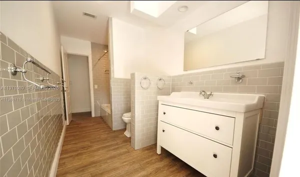 a bathroom with a sink a mirror and a shower