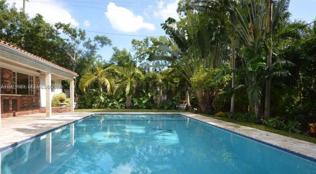 510 Bird Road Coral Gables, FL 33146 - Photo 9 of 9 a view of a swimming pool with an outdoor seating
