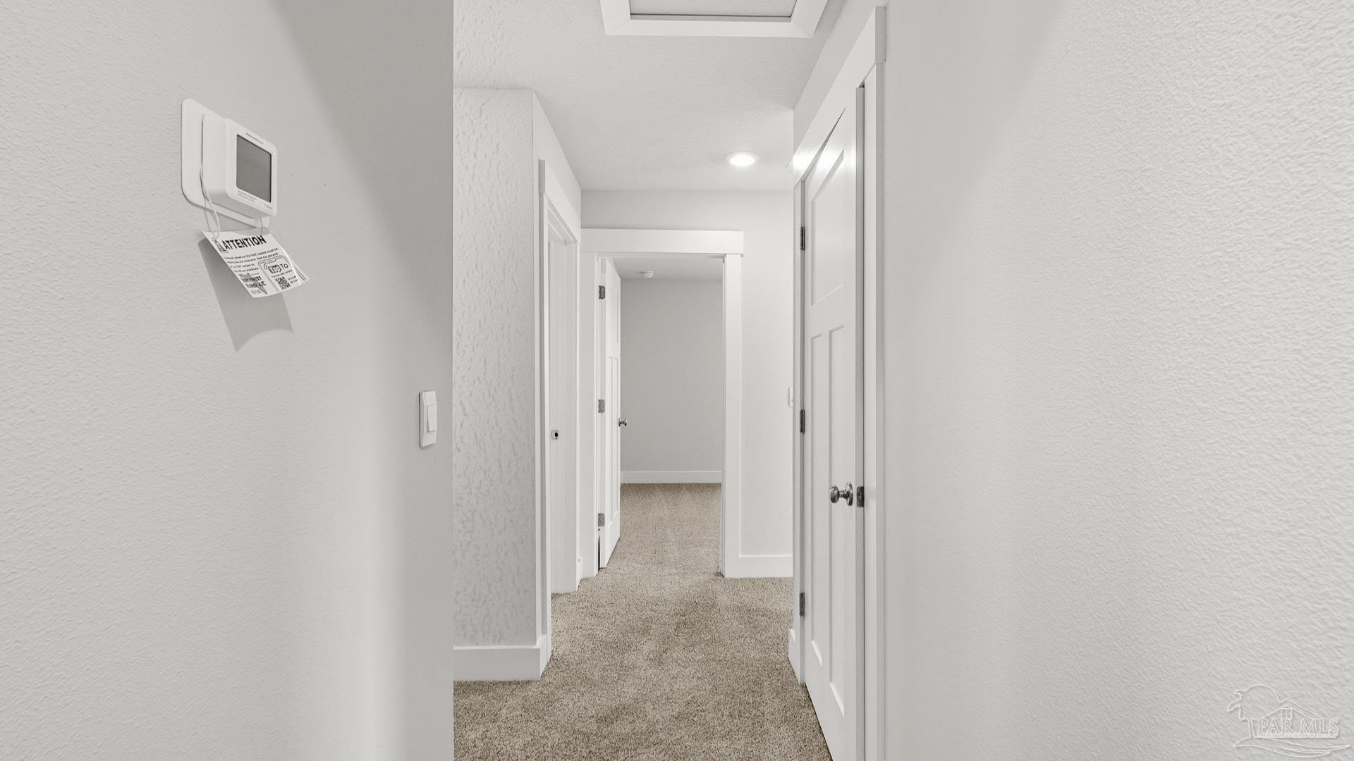 3223 Water Birch Road Cantonment, FL 32533 - Photo 30 of 44 a view of a hallway with paintings on the wall