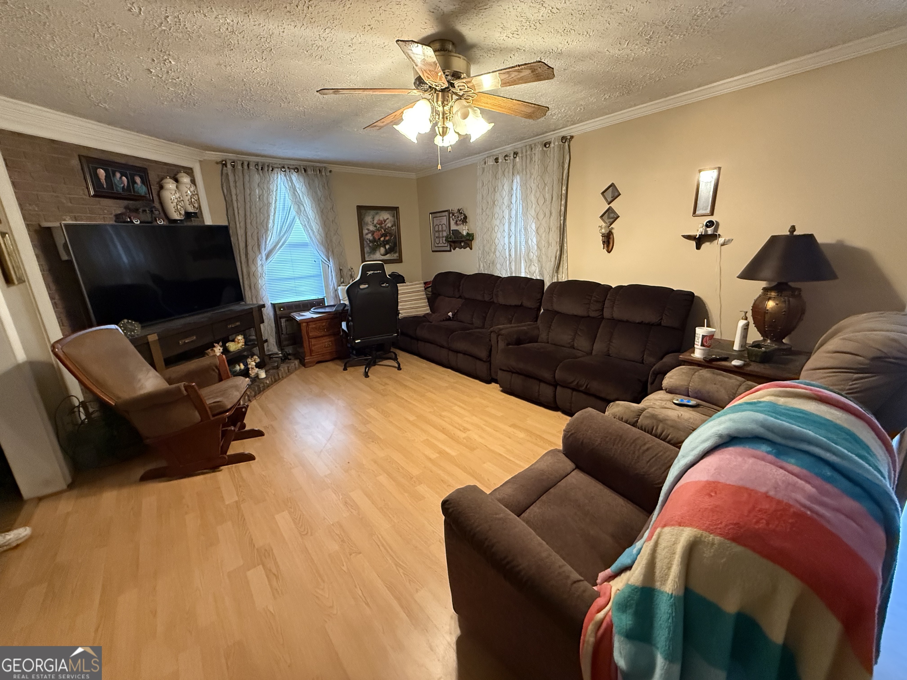 1769 Payne Road Rentz, GA 31075 - Photo 8 of 33 a living room with furniture a flat screen tv and a chandelier