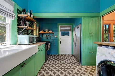 a kitchen with a sink and a stove top oven