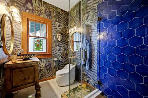 a bathroom with a sink and mirror with toilet