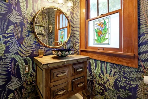 a bathroom with a sink a mirror and a bathtub