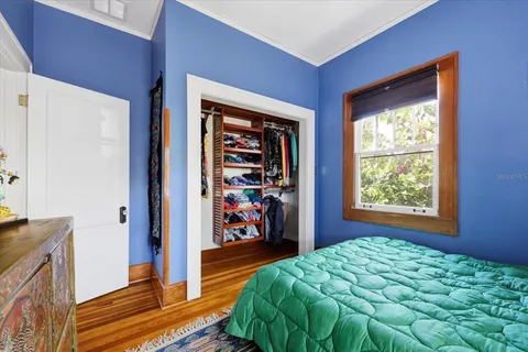 a bedroom with a bed and a window