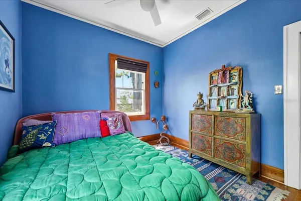a bedroom with a bed and a dresser in it