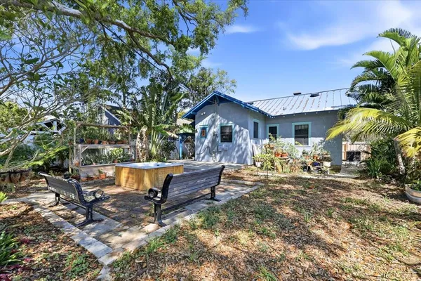 a view of a house with backyard and sitting area
