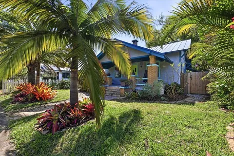 a view of a house with a yard and sitting area