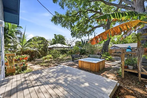 a backyard of a house with barbeque oven table and chairs