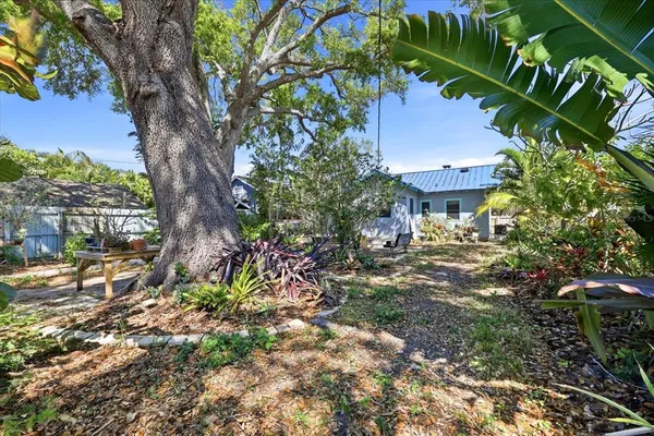 a view of a house with a tree