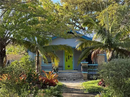 a view of a house with a tree