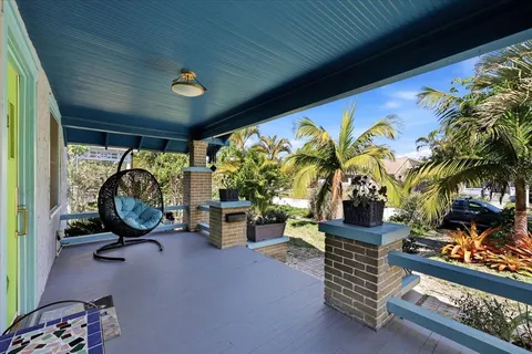 a living room with furniture a chandelier and a large window