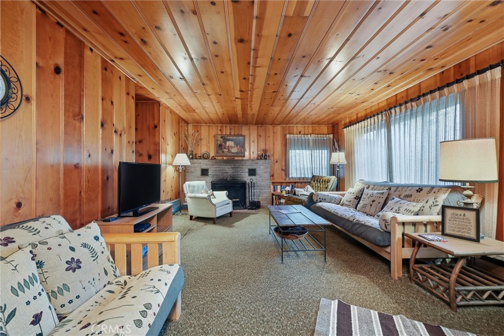 16221 Bottle Rock Road Cobb, CA 95426 - Photo 11 of 21 a living room with furniture a flat screen tv and a large window