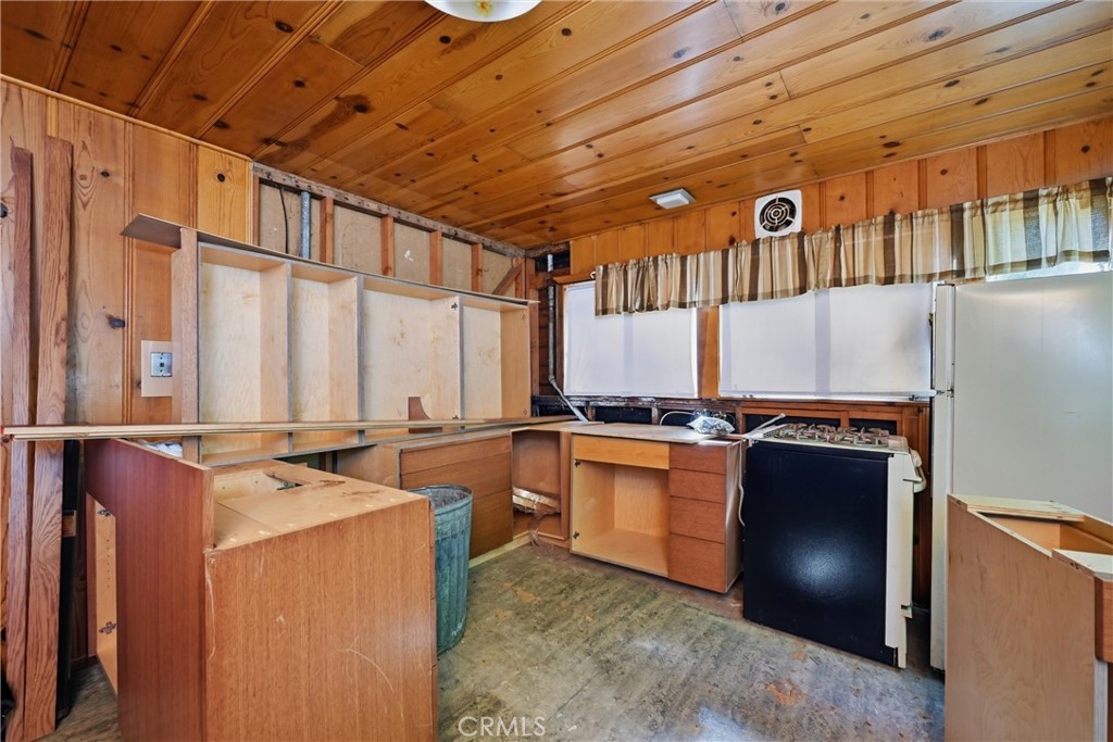 16221 Bottle Rock Road Cobb, CA 95426 - Photo 18 of 21 a kitchen with stainless steel appliances granite countertop a stove a sink and a refrigerator