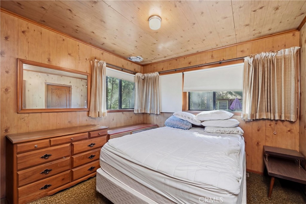 16221 Bottle Rock Road Cobb, CA 95426 - Photo 19 of 21 a bedroom with a bed and large windows