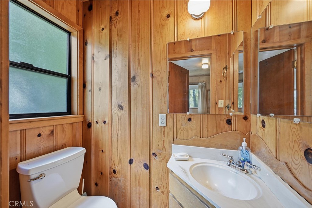 16221 Bottle Rock Road Cobb, CA 95426 - Photo 20 of 21 a bathroom with a granite countertop sink toilet and shower