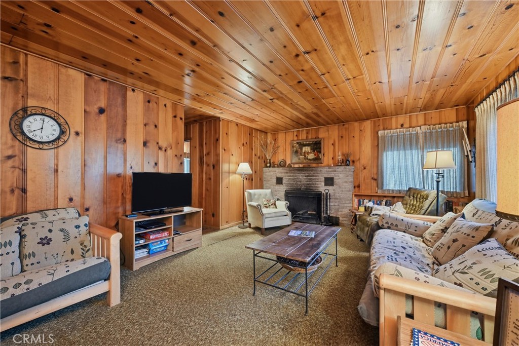 16221 Bottle Rock Road Cobb, CA 95426 - Photo 9 of 21 a living room with furniture a flat screen tv and a fireplace