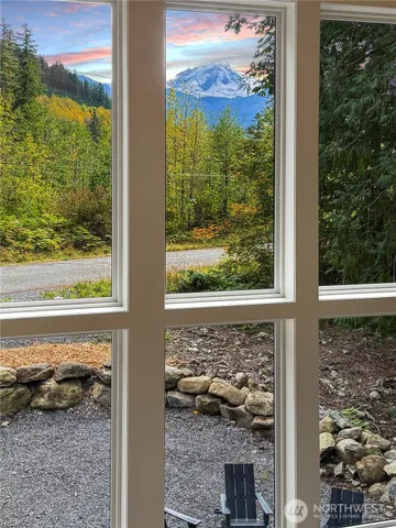 a view of a glass door with a tree