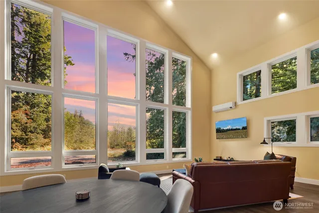 a living room with furniture and large windows