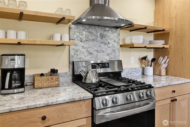 a kitchen with stainless steel appliances granite countertop a stove and a sink