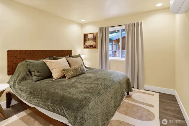 a large bed sitting in a bedroom next to a lamp