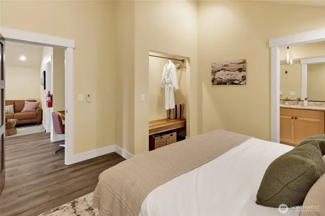 a bedroom with a bed and wooden floor