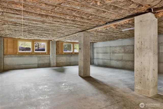 an empty room with a empty space and windows